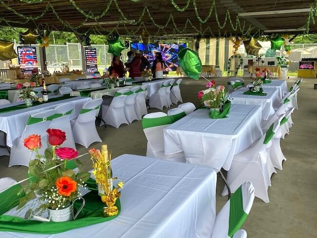 a bunch of tables with tablecloths laid out underneath a pavilion