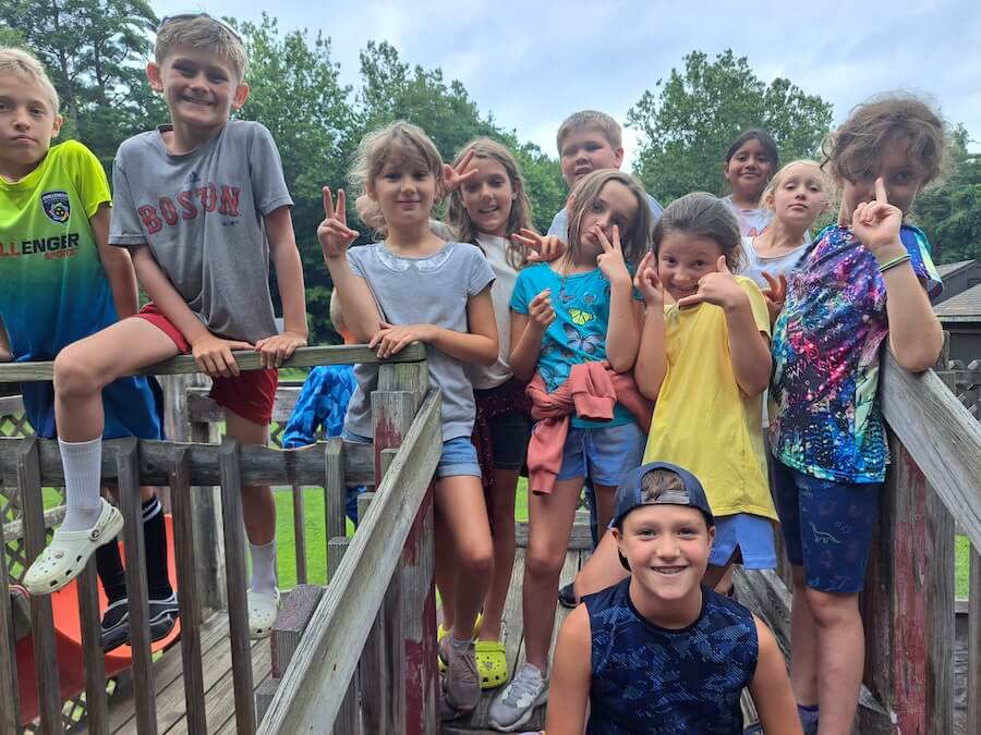 Summer campers posing for a silly photo on a playground